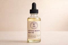 Gentle Roots hair oil by Rooted & Gentle in a clear glass bottle with a dropper neutral label on a light background.